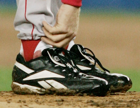 **FILE** Boston Red Sox pitcher Curt Schilling tends to his right ankle during the third inning of game 6 of the ALCS against the New York Yankees in this file photo taken on Tuesday, Oct. 19. 2004, in New York. Baltimore Orioles broadcaster Gary Thorne said Wednesday night, April 25, 2007, that Schilling painted the sock red as a public relations stunt in the Red Sox Game 6 win over the Yankees in the 2004 American League Championship Series. The famous bloody sock is now in the Baseball Hall of Fame in Cooperstown, N.Y. (AP Photo/Charles Krupa, File)